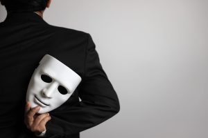 politician or businessman wearing black suit and hiding white ma politician or businessman wearing black suit and hiding white mask